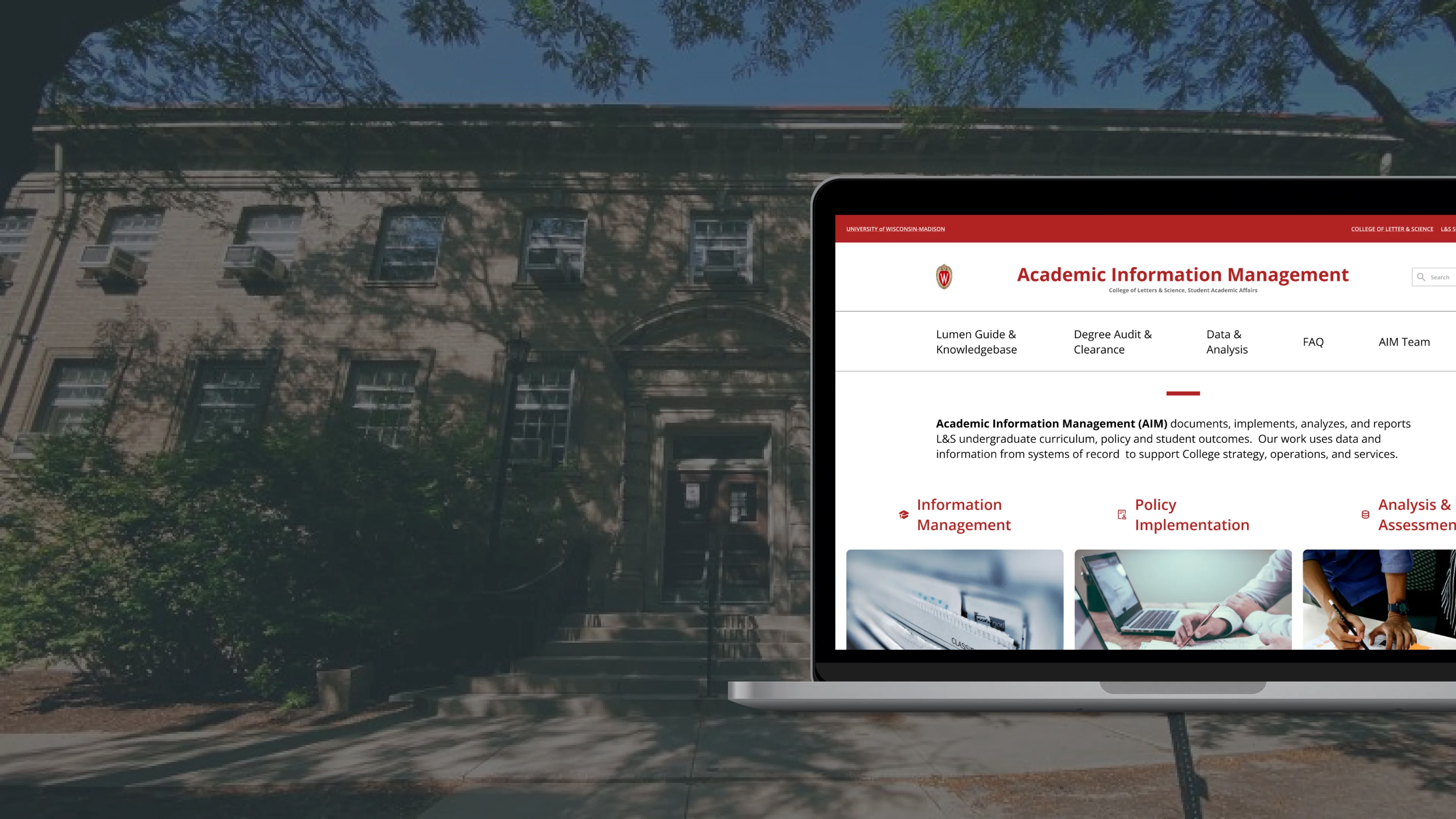 Redesigned AIM home page on a laptop, over a dark photo of the office building